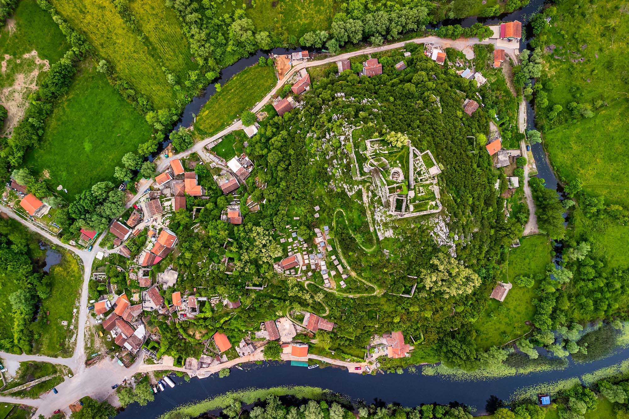 A top view of modern buildings surrounded by trees in Podgorica, Montenegro