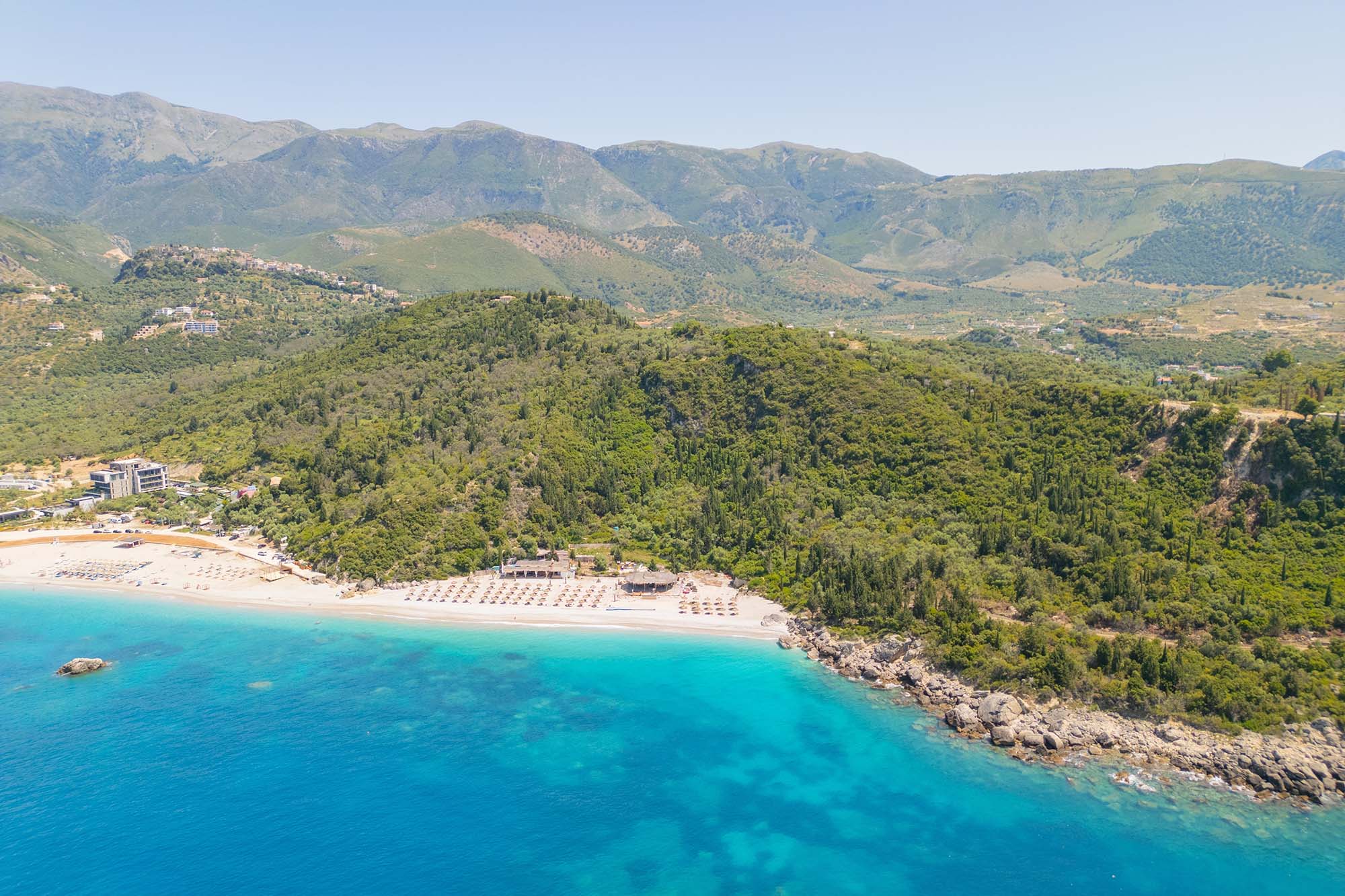 Aerial view of beach clubs along the Himare coastline part of the Albanian Riviera on the Ionian Sea in southern Albania